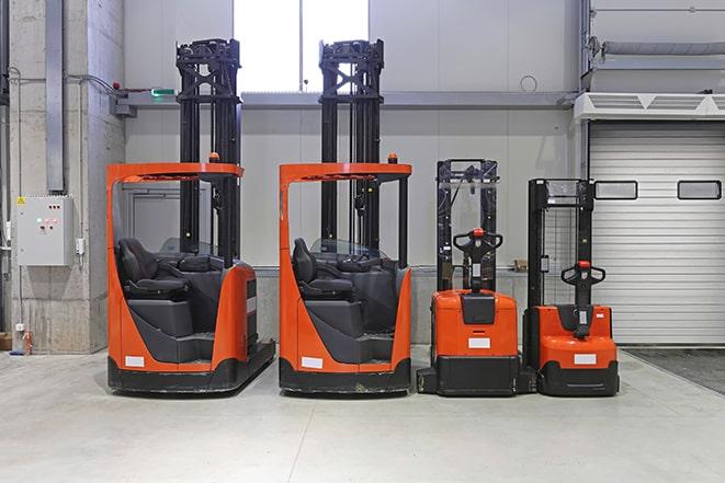 forklifts maneuvering through a warehouse aisle